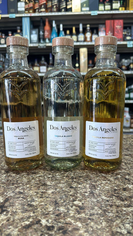 Dos Angeles Tequila 3 Bottle Combo featuring Blanco, Rosa, and Reposado varieties with elegant labels in a liquor store setting. Dos Angeles Tequila 3 Bottle Combo featuring Blanco, Rosa, and Reposado varieties with elegant labels in a liquor store setting.