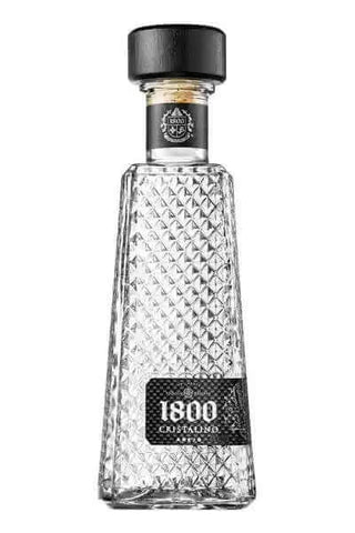 Bottle of 1800 Cristalino Tequila featuring diamond-patterned glass and black cap. Bottle of 1800 Cristalino Tequila featuring diamond-patterned glass and black cap.