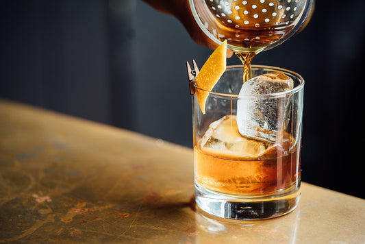 liquor pouring on a clear shot glass