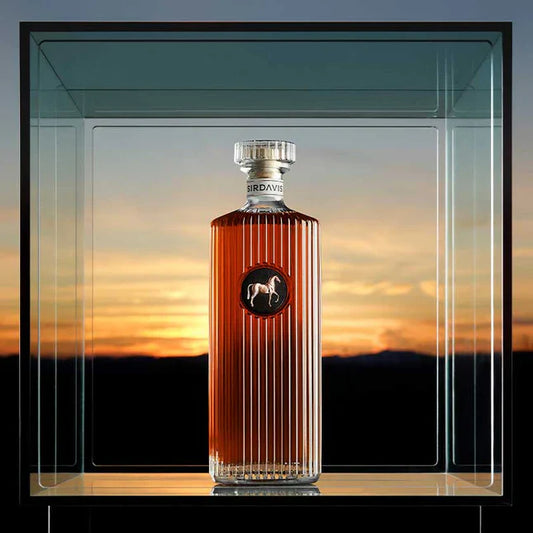 SirDavis American Whisky bottle with sunset background, representing a blend of tradition and innovation in premium spirits.