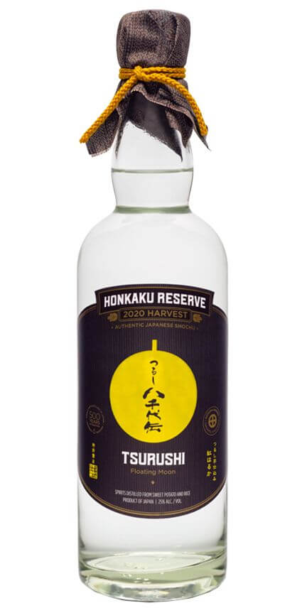 "Bottle of Honkaku Reserve Tsuruishi Shochu 2020 Harvest, a Japanese distilled beverage with a yellow label and black cloth-wrapped cap."